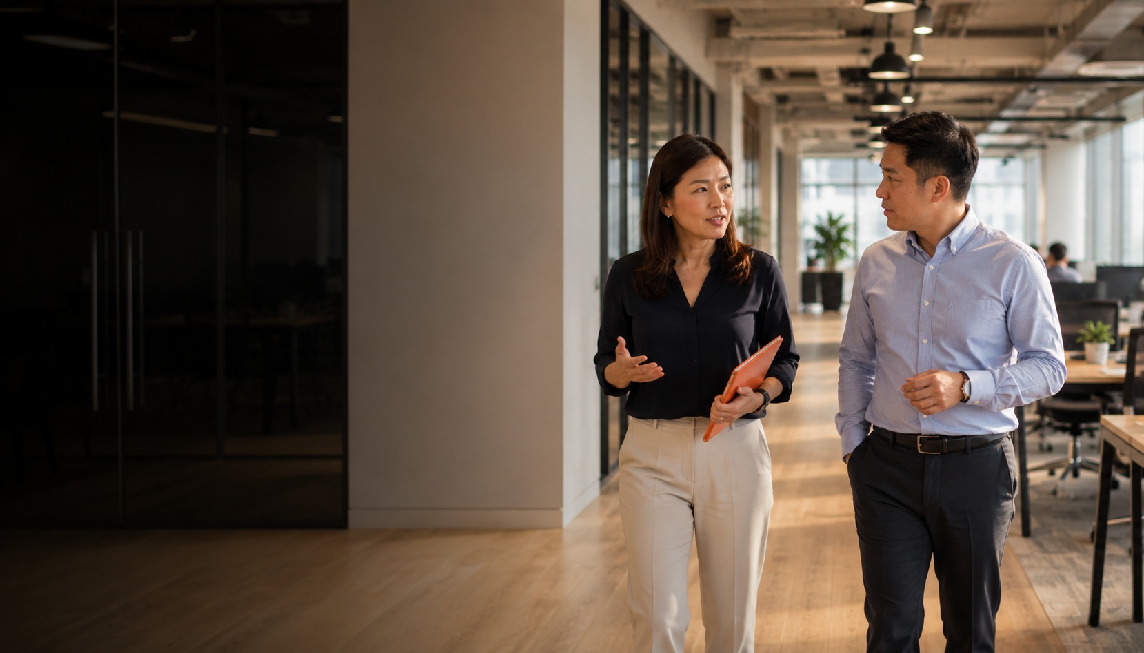 HR Shared Services Vietnam - People Profilers HR consultant walking with client through a Thailand office, mid-conversation about HR services